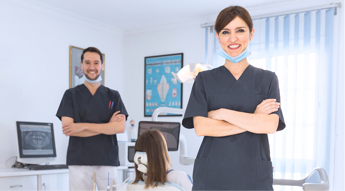 Dental professionals smiling in a clinic
